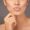 Closeup studio shot of a woman with gorgeous glossy lips against a gray background