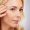 Face, skincare and antiaging with a mature woman in studio on a gray background for natural beauty.