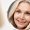 Happy mid aged woman looking at mirror. Antiaging beauty care concept.